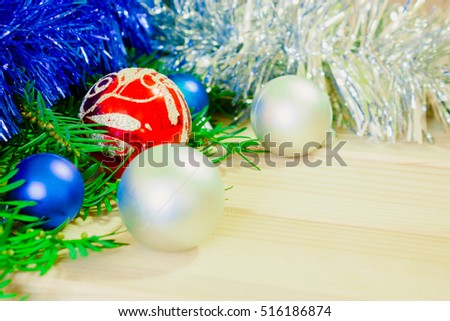 Christmas background with pine tree branches, decorations and baubles on wooden board