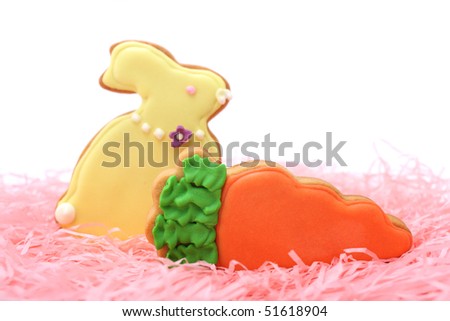 Close up of easter cookies on pink ribbons over white background.