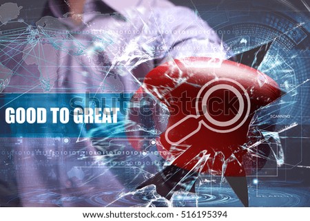 Business, Technology, Internet and network concept. Young businessman breaks the virtual future of the screen on which the inscription: good to great 