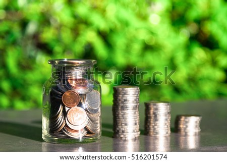 Savings money jar full of coins concept for saving or investment for a house, retirement or education. Finance concept, Money coin stack growing graph. Good Interest. high risk high return 