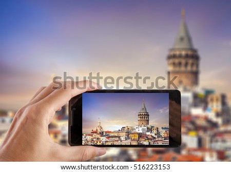 Travel concept. Hand making photo of city with smartphone camera. Istanbul. Turkey.