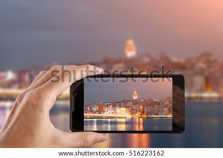Travel concept. Hand making photo of city with smartphone camera. Istanbul. Turkey.