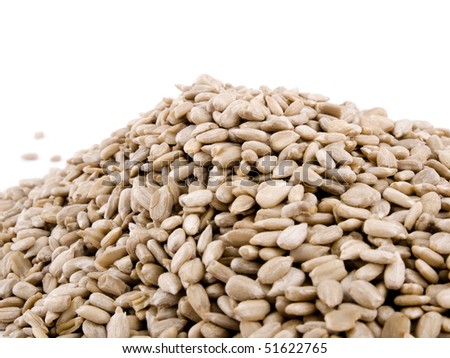 Closeup picture of sunflower seeds heap against white background