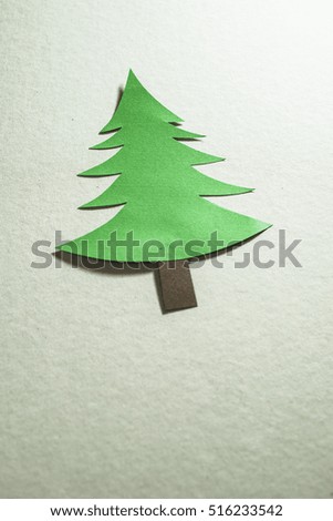 Christmas pine tree made of paper on paper background. Origami christmas tree