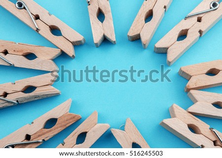 Wooden Vintage Clothes Clips on Blue Background.
