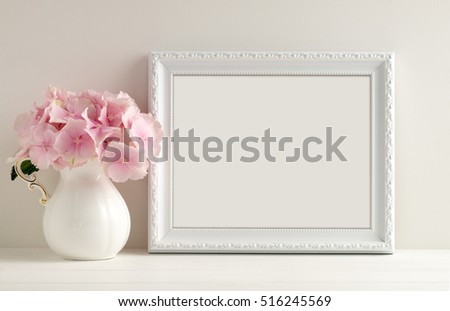 White landscape frame mock up with a vase of hydrangea beside the frame, overlay your quote, promotion, headline, or design, great for small businesses, lifestyle bloggers and social media campaigns