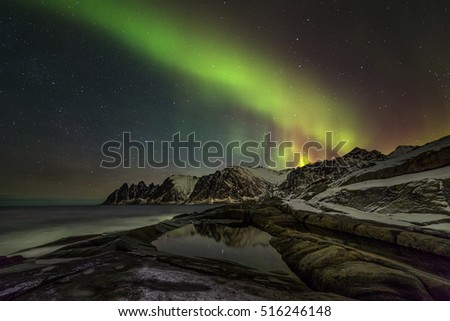 Aurora borealis (Polar lights) over the mountains in the North of Europe - Senja island, Troms county, Norway 
