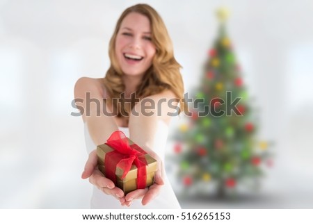Beautiful woman holding a gift during christmas time