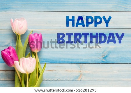 Happy birthday/ Tulips on blue boards with text happy birthday.