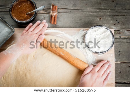 Girl makes homemade scones, rolls yeast dough, top view, hands in picture