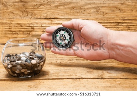 Sea stones, the hand with a compass on the boards.