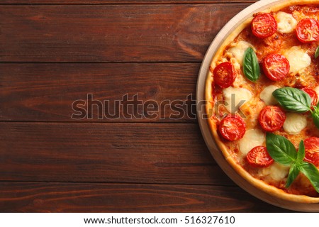 Pizza Margarita on wooden background