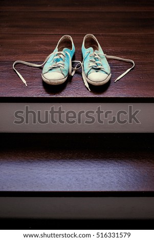 Youth and travel. Old used gumshoes on the wooden background.