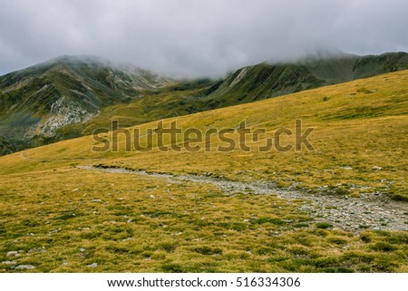 Hiking the Pyrenees Mountains on a cloudy day.