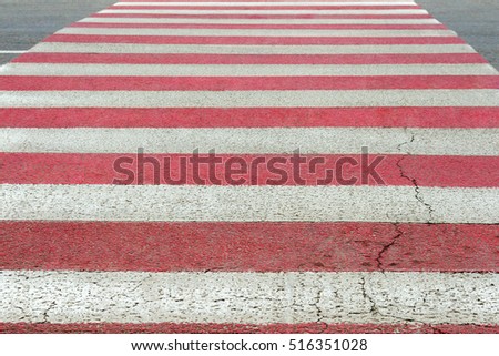 Striped crosswalk on the road in perspective with shallow depth of field