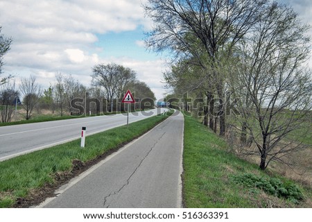 View of the road and bicycle path in early spring.