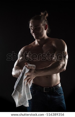 Brutal man bodybuilder athlete on a black background.