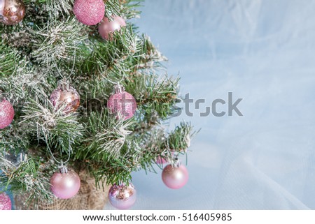 Christmas Holiday Background, Hanging pink baubles on Christmas tree, New Year backdrop, Decoration. Abstract blue Blurred Bokeh. Christmas Tree decorated.