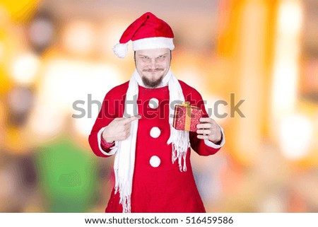 Funny man dressed as santa claus with gift