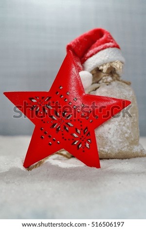 The red star on the wooden background bag of gifts. The magic of Christmas