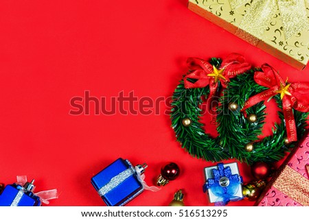 Many colors gift boxes placed Merry christmas on red background