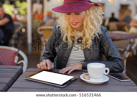 Woman at cafe using tablet computer