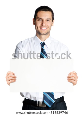 Smiling young businessman showing blank signboard, isolated on white background. Empty copyspace area for slogan or advertising text message. Success, business, job and education concept studio shot.
