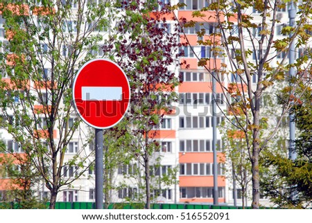 Traffic sign "No entry" on the background of trees and residential house