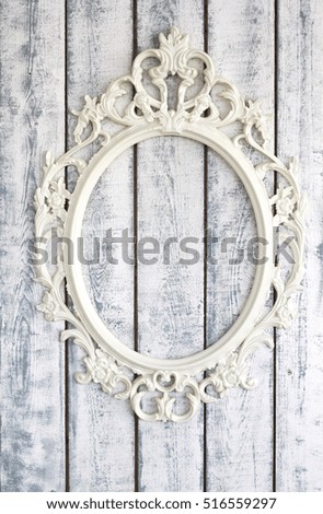 White wooden wall with vintage frame