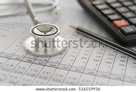 medical billing,  stethoscope and calculator on bills for health care costs or medical insurance.