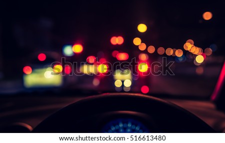 vintage tone blur image of inside cars with bokeh lights from traffic jam on night time for background.