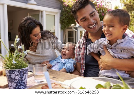 Family At Home Eating Outdoor Meal In Garden Together Royalty-Free Stock Photo #516646258