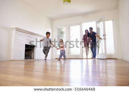Excited Family Explore New Home On Moving Day Royalty-Free Stock Photo #516646468