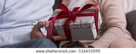 Man gives a gift to his beloved woman