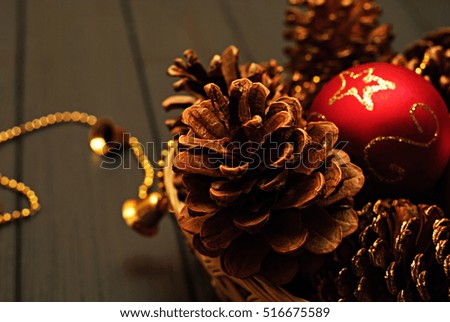 Red and golden Christmas decorations on gray wooden background