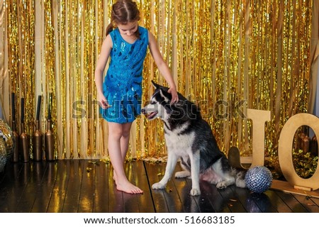 Child girl on stage to train a big dog.