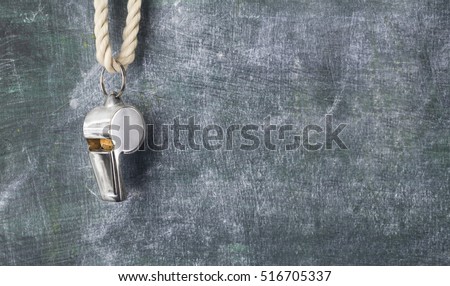 whistle of a soccer / football referee or trainer, free copy space Royalty-Free Stock Photo #516705337