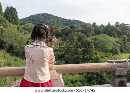 Women Wearing Kimono Taking Photo with Her Mobilephone of Land Scape in Kyoto City, Japan