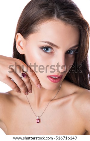 Portrait of young beautiful woman with diamond ring and necklace. Isolated on white