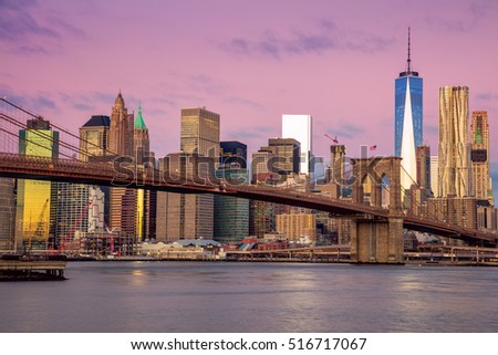 Sunrise colors of Brooklyn Bridge and  Manhattan offices skyline in New York City,  USA