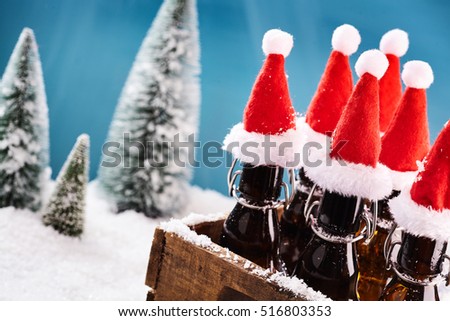 Tasty beer bottles for winter party in a brown wooden basket in front of wintery landscape