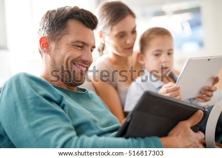 Parents with kid connected on digital tablet