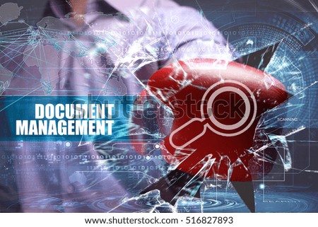 Business, Technology, Internet and network concept. Young businessman breaks the virtual future of the screen on which the inscription: document management 