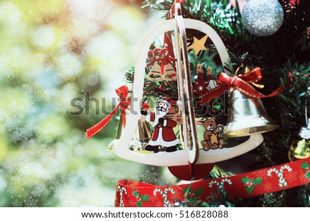 Close up the wood Santa Claus at Christmas tree with snow bokeh light.