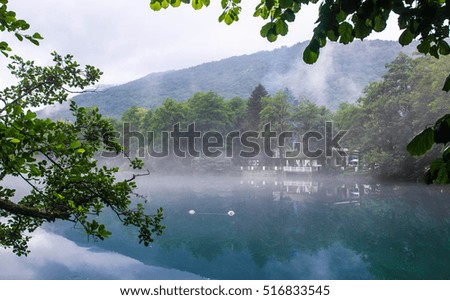 Fog creeps over the water of Lower Blue Lake, Kabardino-Balkaria Republic,Russia