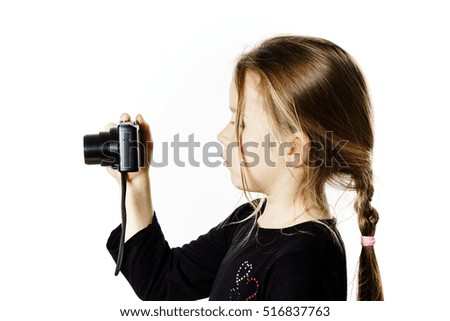 Cute little girl with compact digital camera, isolated on white background