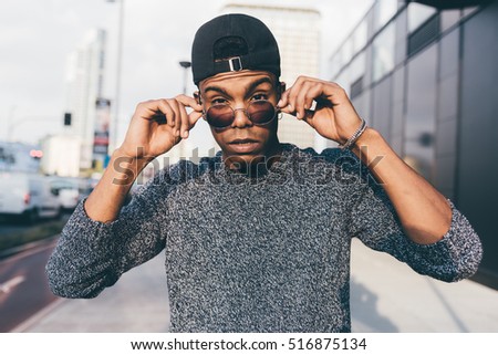 Young handsome american african swag man outdoor in the city looking in camera, rebel - rebellion, swag, contemporary concept Royalty-Free Stock Photo #516875134