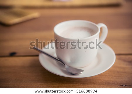 Cup of coffee on a wooden table sweet tone