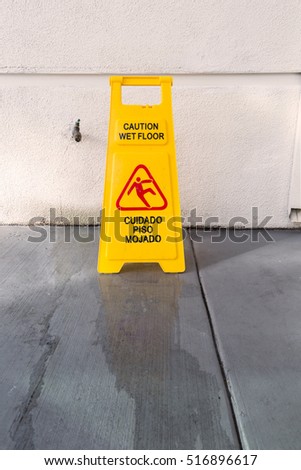 Slippery floor surface warning sign and symbol in building, hall, office, hotel , restaurant, restroom. Concept photo danger.