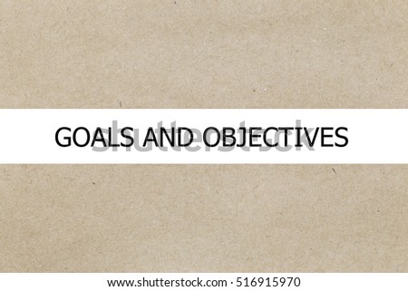 Goals and Objectives words written under torn brown paper.